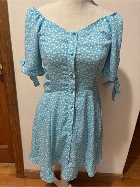 Woman’s size small dress in blue & white. Short sleeves with ties. Like new.
